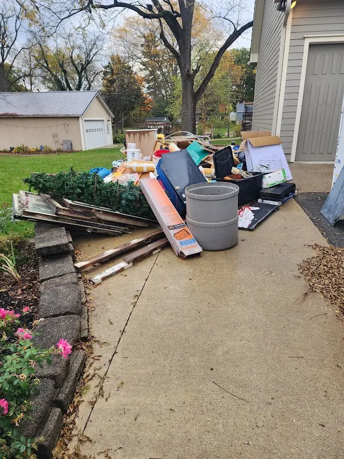 Dumpster being loaded with debris for Estate Cleanout Dumpster Rental in Tiffin